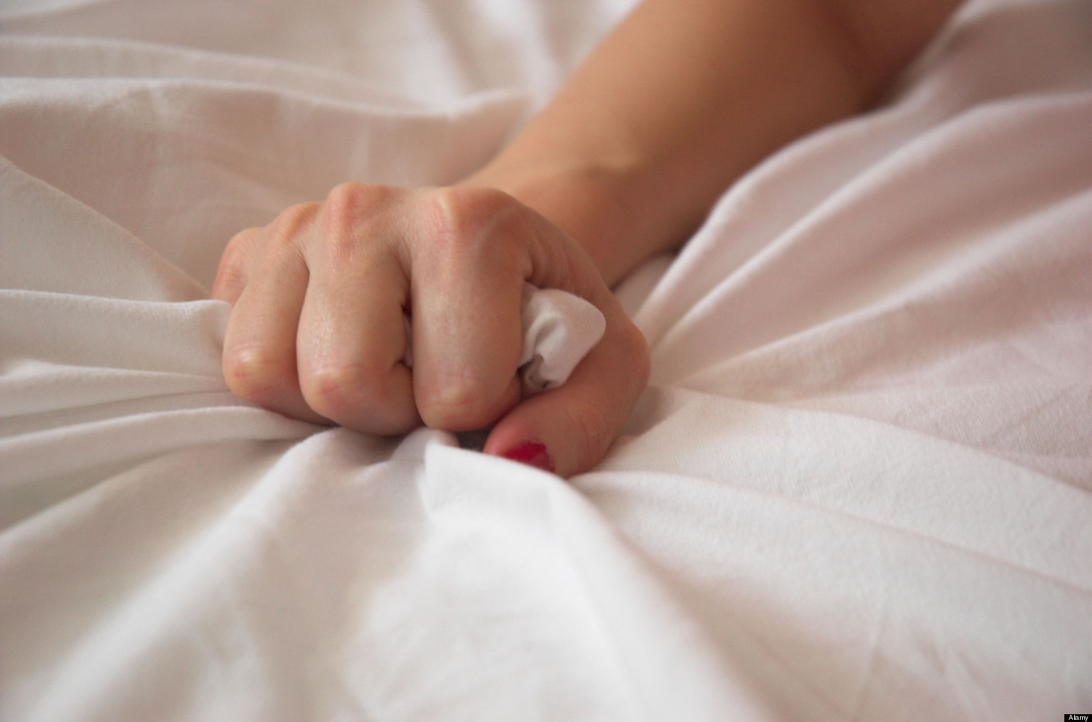 Woman s Hand Squeezing Bed Sheet